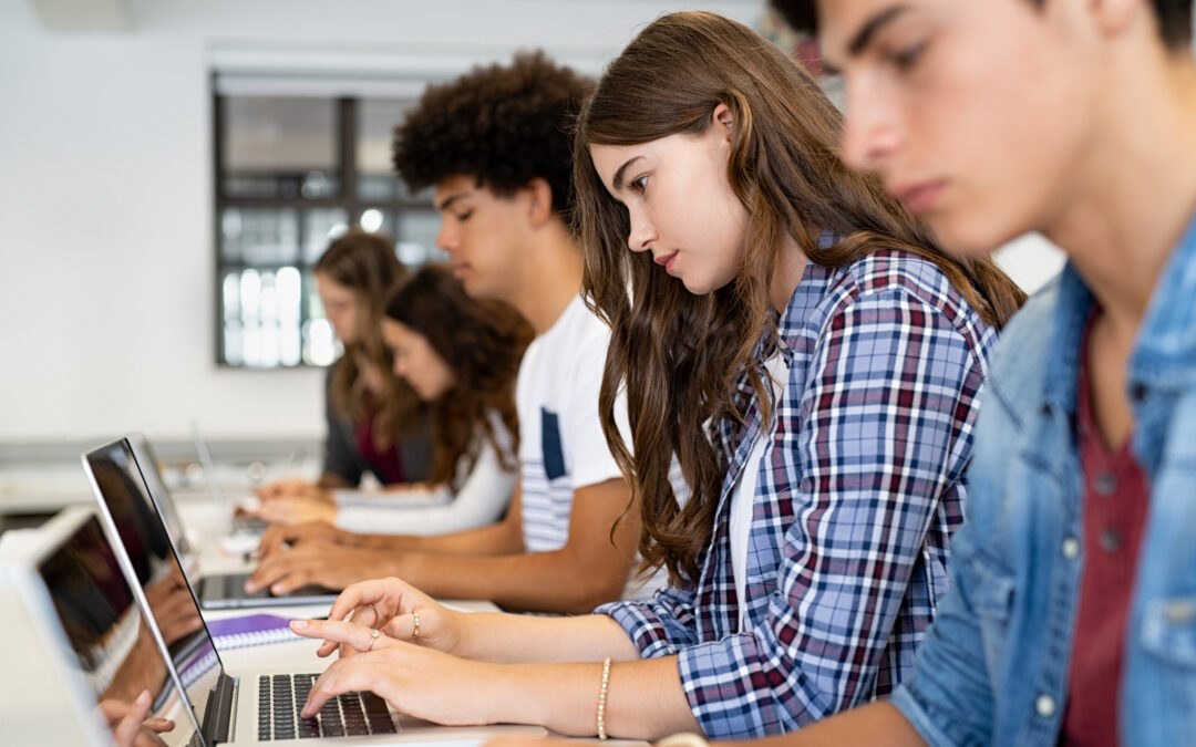 Students in computer class practicing keyboarding for academic success