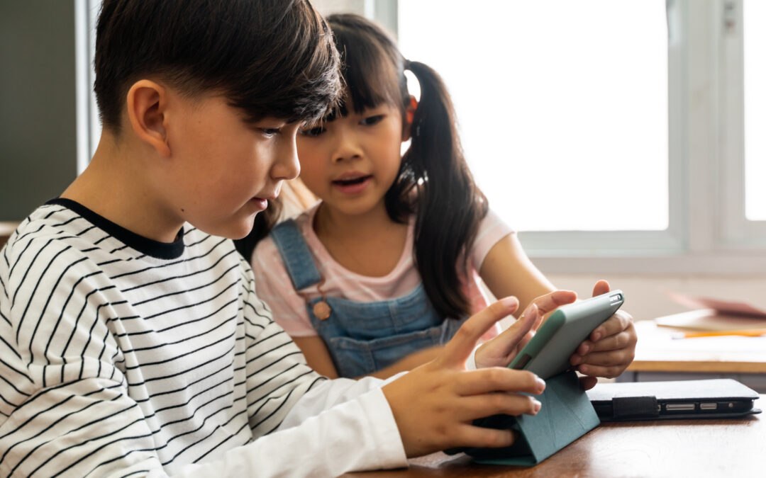 Students on tablet engaging in digital literacy curriculum