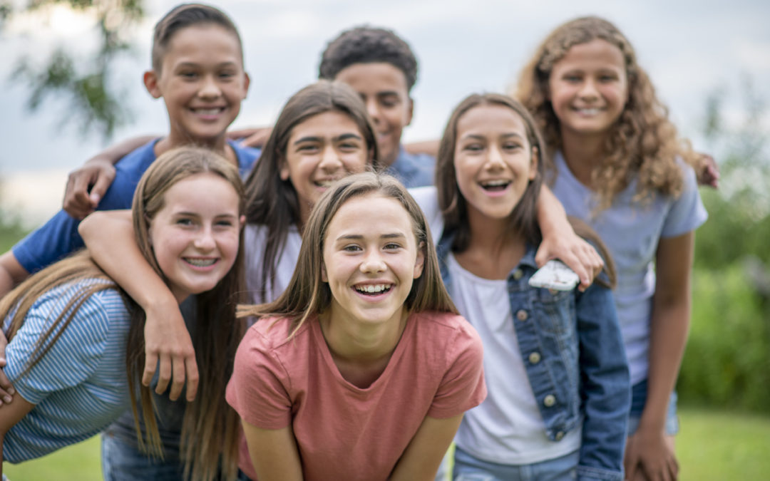 Group of students smiling at camera celebrating safety after studying digital citizenship online