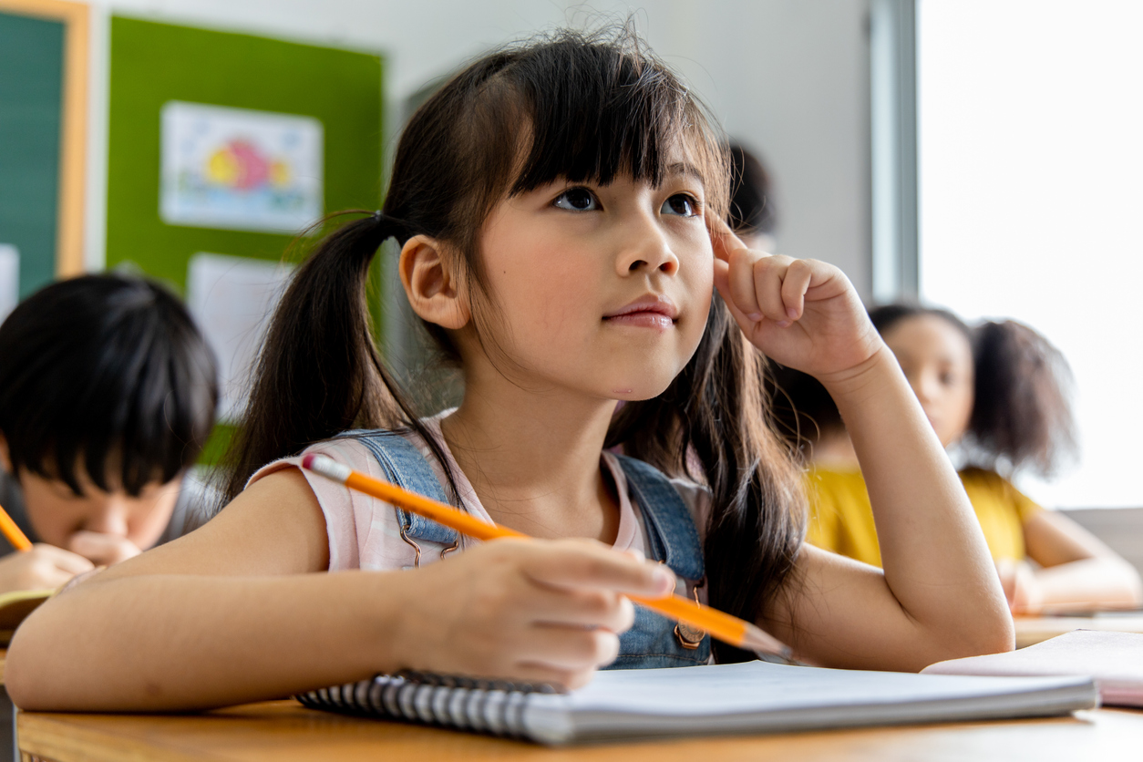 Young student at school desk practicing computational thinking algorithmic thinking and design thinking skills