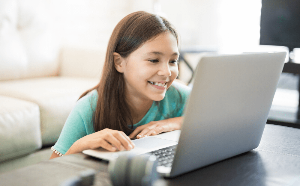 Smiling girl in front of laptop